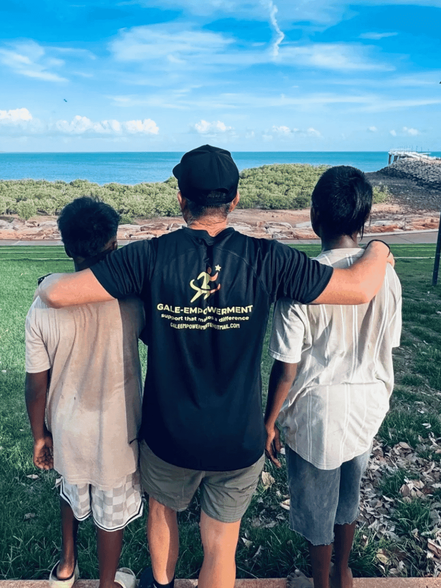 A Gale Empowerment support worker alongside participants overlooking the Broome coastline
